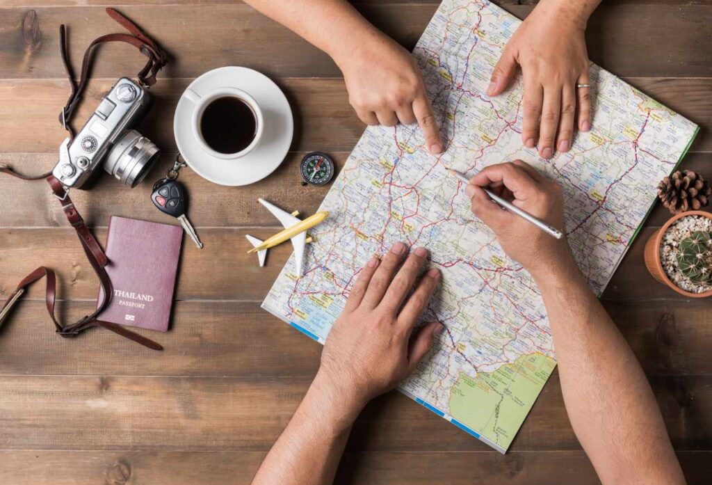 top view of couple planning a vacation trip with map