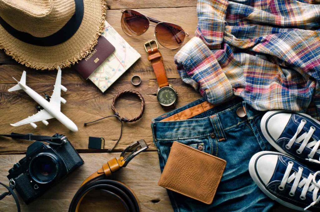 Travel accessories and clothes on wooden floor