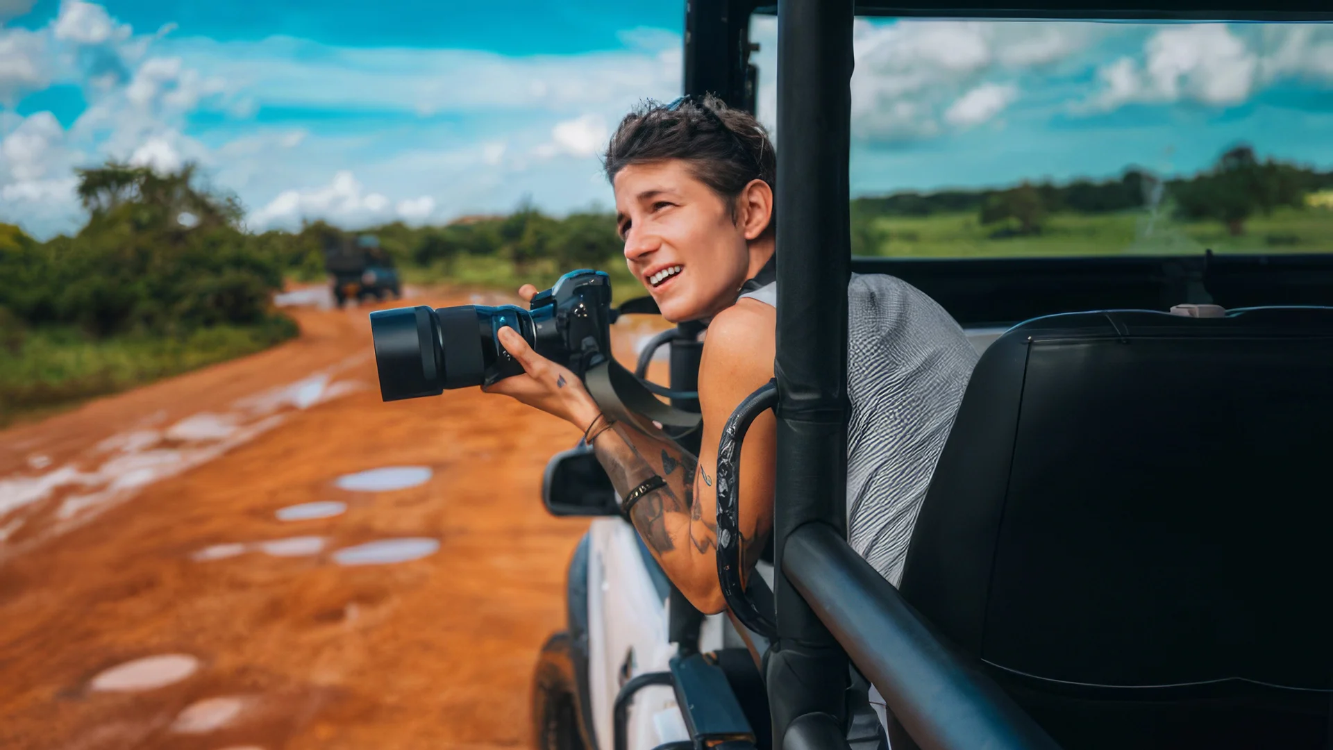 How to take better travel photos: a woman capturing wildlife on a safari for photography tips