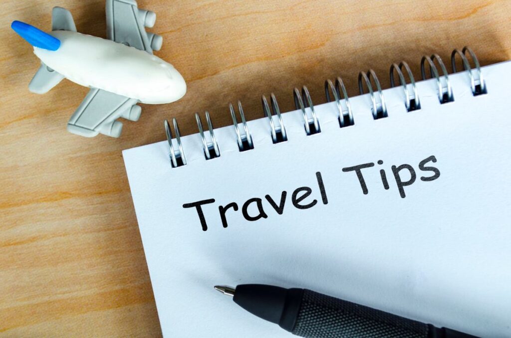 Travel Tips text on white notepad