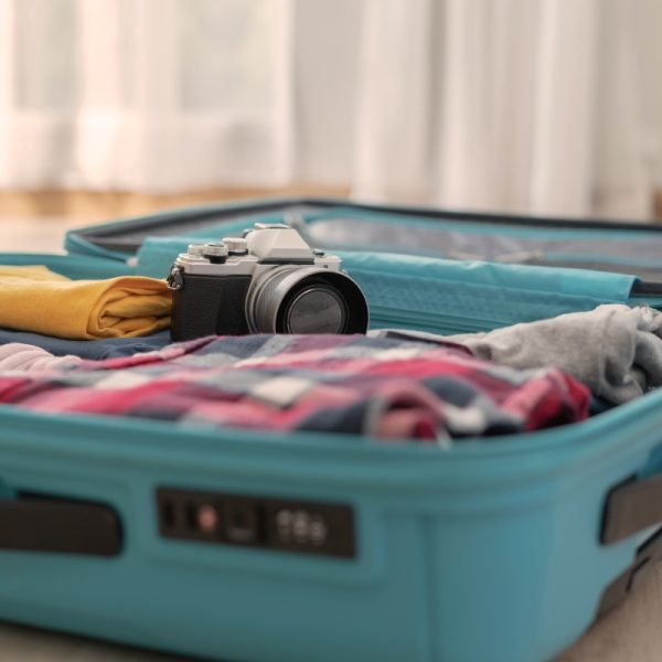 travel luggage with clothes and camera