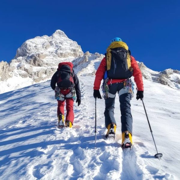 people climbing a snowy mountain