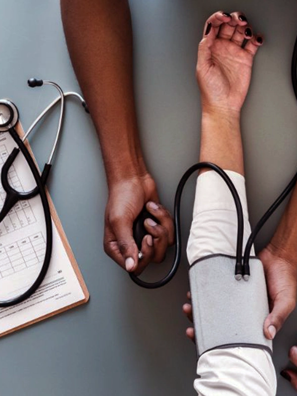 Healthcare proffesional measuring a patients`s blood pressure in a sustainable tourism wellness setting