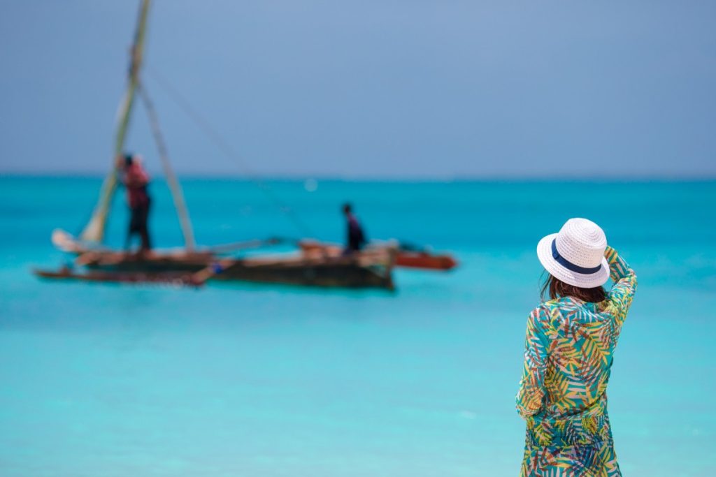 Young beautiful woman on beach during tropical vacation in Zanzibar